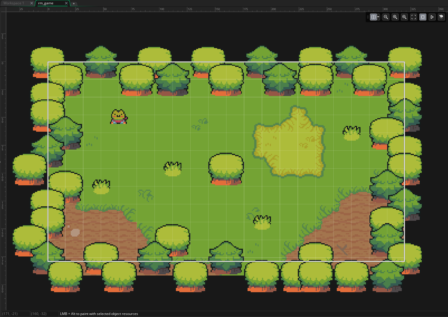 The finished forest clearing in GameMaker, with a mixed border of two kinds of tree around a decorated, painted floor.